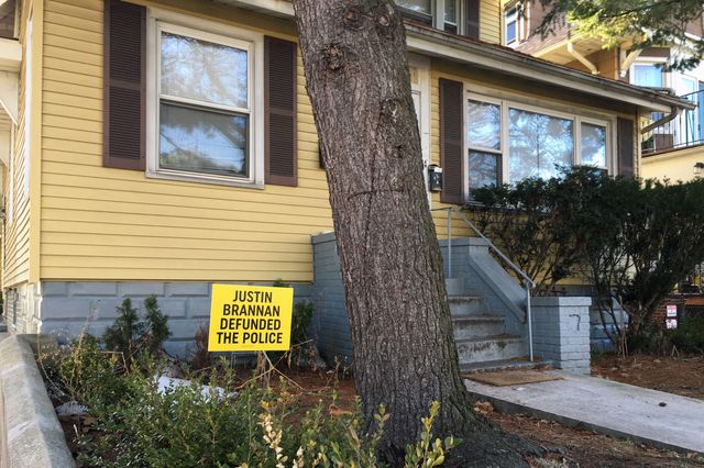 An exterior shot of a two-story home in Brooklyn. A sign posted on the small front lawn reads in capital letters, "Justin Brannan defunded the police."